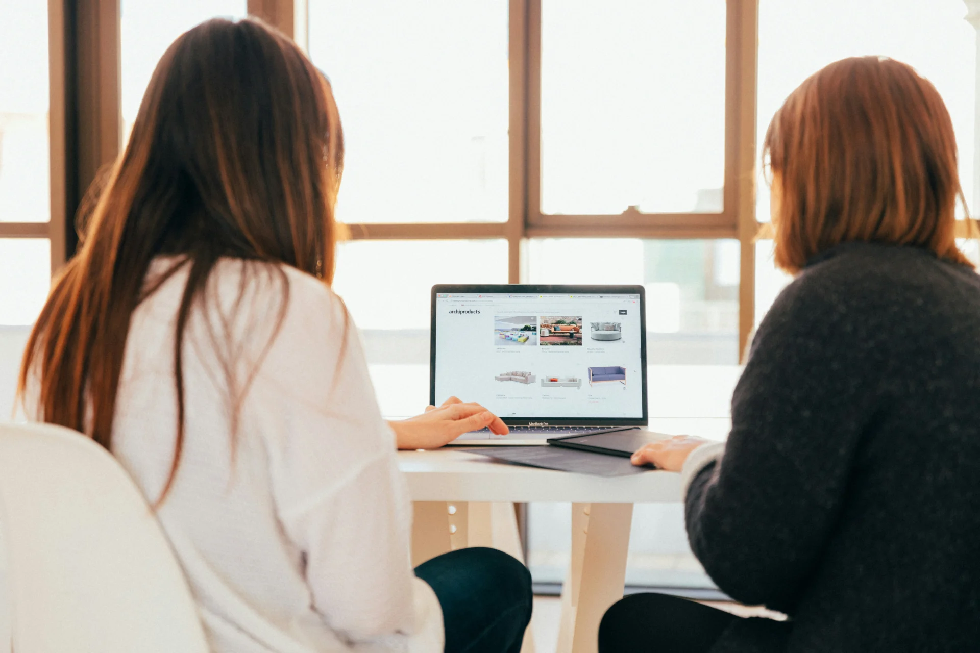 2 women looking at computer